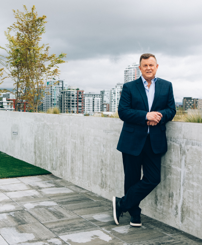 Mike Bishop, Vice President of Property Management for Third Space Properties, posing with the Vancouver skyline in the background.