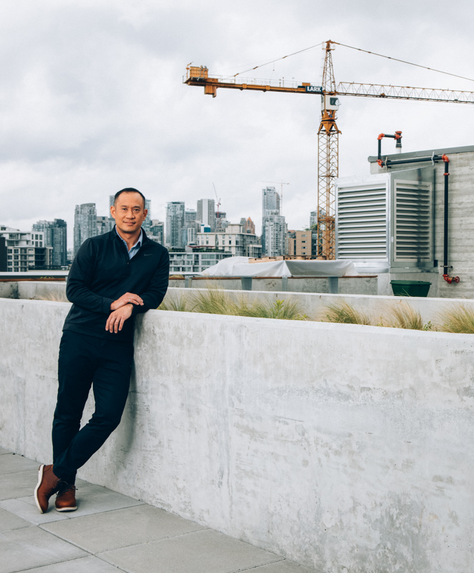 Ryan The, Executive Vice President of Third Space Properties, posing with the Vancouver skyline in the background.