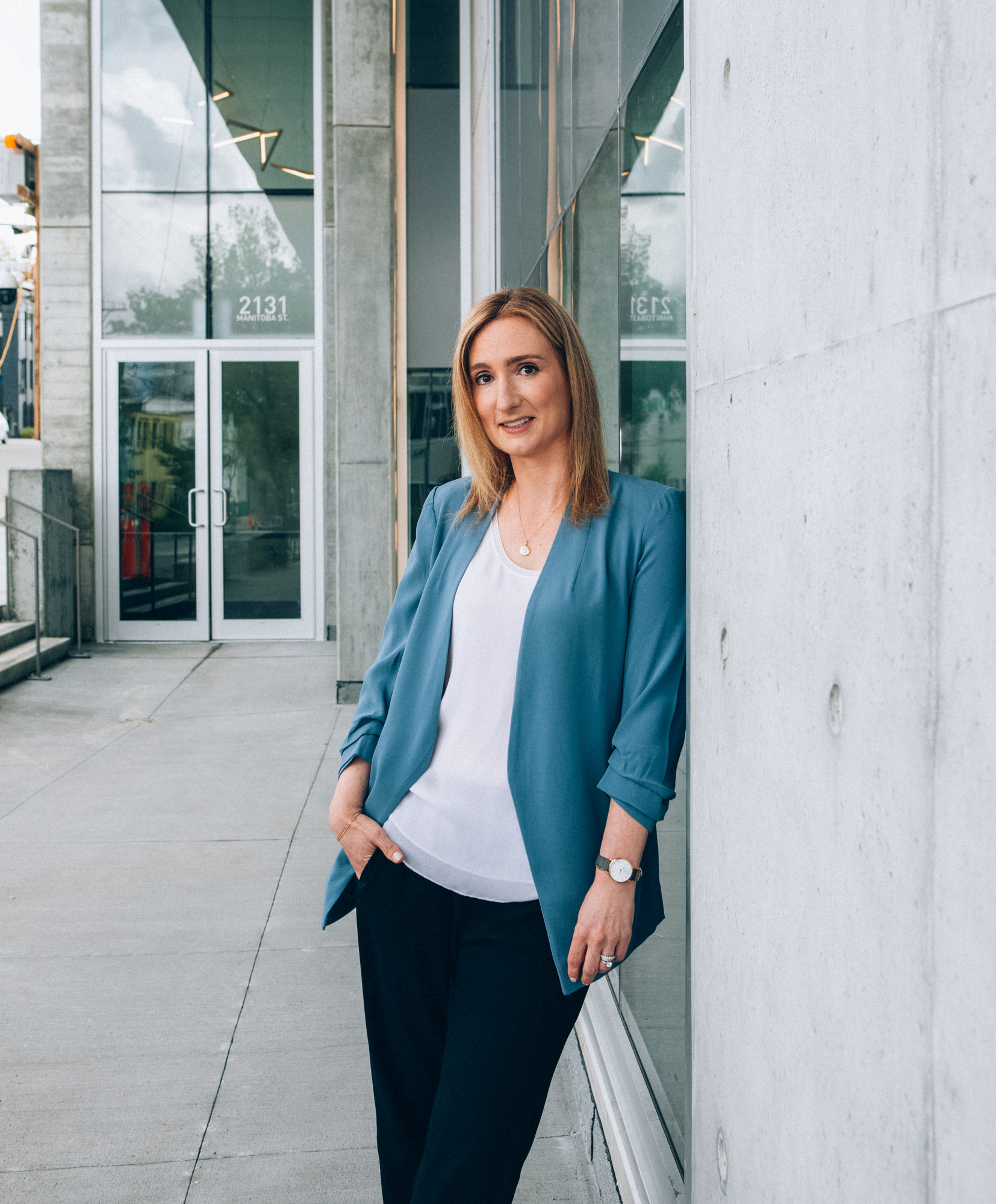 Sarah Small, Vice President of HR at Third Space Properties, posing against a building in Vancouver.