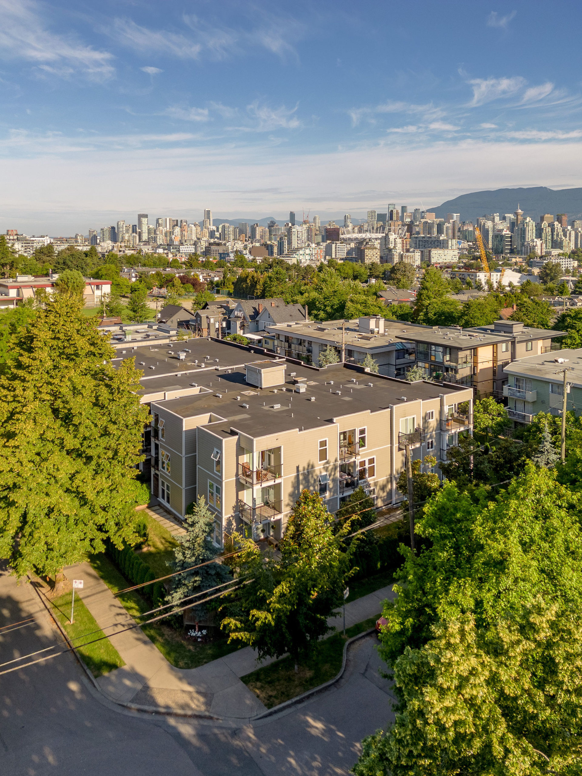 An aerial view of Watson Manor, a three-storey residential rental building at East 8th Avenue and Carolina Street in Mount Pleasant, Vancouver.